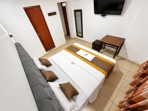 a bedroom with a bed and a table and a television at Hotel World Peru in Lima
