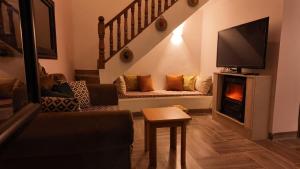 a living room with a couch and a fireplace at le petit paradis in Chaba Remada