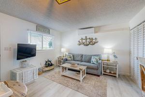 a living room with a couch and a tv at MA221 The Tropical Cove 329 in Marathon