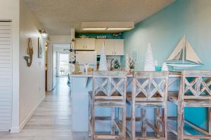 a kitchen with a bar with two stools at MA221 The Tropical Cove 329 in Marathon