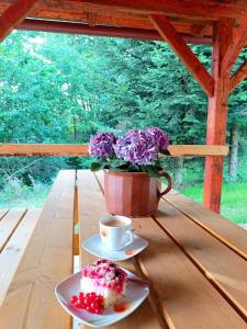 a table with a cup of coffee and a plate of cake at Ubytování Krucemburk in Křížová
