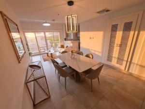 a dining room and living room with a table and chairs at PH Palash Tower in Rousseau