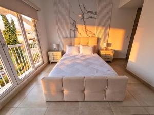 a bedroom with a large bed and two windows at PH Palash Tower in Rousseau +291 photos