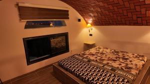 a bedroom with a bed and a brick wall at le petit paradis in Chaba Remada +48 photos
