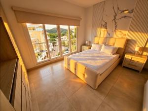 a bedroom with a bed and a large window at PH Palash Tower in Rousseau