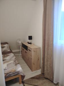 a room with a wooden dresser and a window at Vikendica na Jazu in Kosjeric +77 photos