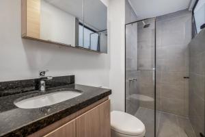 a bathroom with a toilet and a sink and a shower at Park 38 in Envigado +108 photos