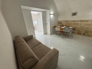a living room with a couch and a table at Le Dimore Airport Luxury in Bari