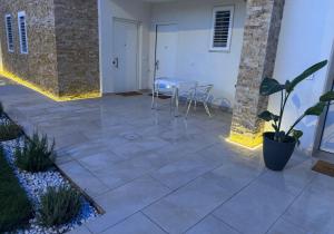 a patio with a table and chairs on it at Le Dimore Airport Luxury in Bari +2 photos