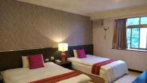 Postel nebo postele na pokoji v ubytování Liwu Hotel Taroko