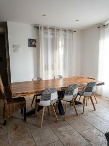 a wooden table and chairs in a room at Villa J et V in Bédarrides