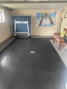 an empty room with a gym with a table and chairs at Hausamaarbach in Willingen