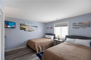 a bedroom with two beds and a window at Astronaut Motel in Wildwood Crest +33 photos