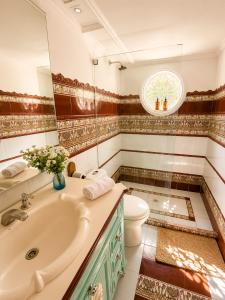 a bathroom with a sink and a toilet and a mirror at Hotel Isla Azul - Islas del Rosario in Isla Grande +35 photos