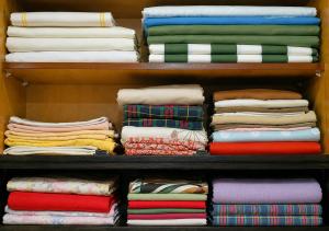 a shelf filled with lots of colorful shirts at Vintage 4BR Borjomi Hideaway in Borjomi +30 photos