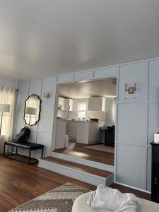 a living room with white walls and a room with a couch at Sherkston Shores Cottage in Port Colborne
