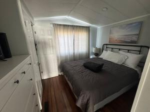 a bedroom with a bed with a pillow on it at Sherkston Shores Cottage in Port Colborne
