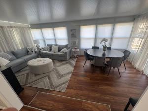 a living room with a couch and a table at Sherkston Shores Cottage in Port Colborne
