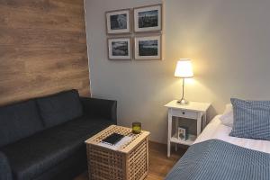 a living room with a couch and a bed at Thoristun Apartments in Selfoss