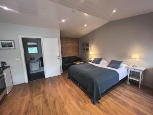 a bedroom with a bed and a living room at Thoristun Apartments in Selfoss