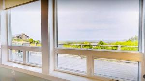 a window with a view of the ocean at Alta Vista in Pacific City