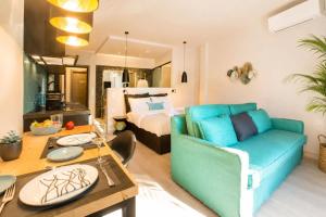 a living room with a couch and a bed at Ermou w Jacuzzi Acropolis View Monastiraki in Athens
