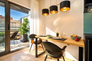 a dining room with a table and chairs and a balcony at Ermou w Jacuzzi Acropolis View Monastiraki in Athens +26 photos