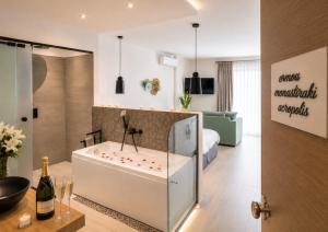 a hotel room with a tub in the middle of a room at Ermou w Jacuzzi Acropolis View Monastiraki in Athens