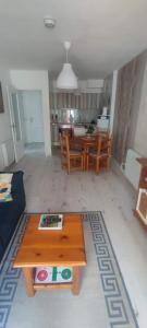 a living room with a table and a kitchen at Carlina Canfranc in Canfranc-Estación