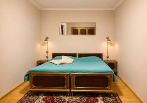 a bedroom with a bed and a mirror on the wall at Vintage 4BR Borjomi Hideaway in Borjomi