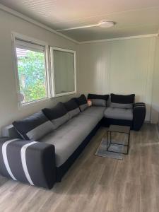 a large couch in a living room with a window at Villa Viva Jama in Novi Sad +1 photo