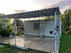 a pergola with a stage in a yard at Villa Viva Jama in Novi Sad