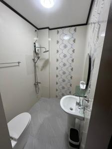 ein weißes Badezimmer mit Toilette und Waschbecken in der Unterkunft SouthPark Hotel Naga in Concepcion + 24 Fotos