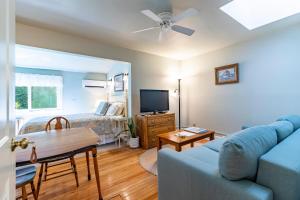 a living room with a couch and a bed at Sylvan Inn Bed & Breakfast in Glen Arbor