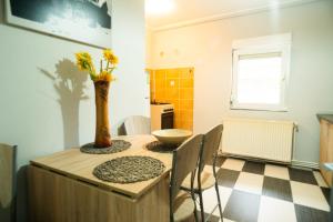 a kitchen with a table with a vase on it at Elite Apartament Hunedoara in Hunedoara
