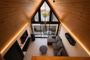 an attic view of a living room with a large window at NOE Suites in Ayios Theodhoros +16 photos