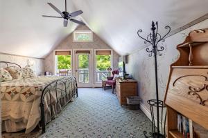 a bedroom with a bed and a ceiling fan at Sylvan Inn Bed & Breakfast in Glen Arbor