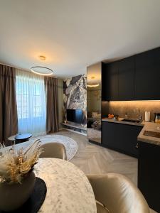 a kitchen and living room with a table and chairs at Kalan Boutique Stay in Žirovnica +49 photos