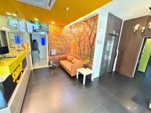 a living room with a couch and a wall mural at Smile Hotel Danau Kota in Kuala Lumpur