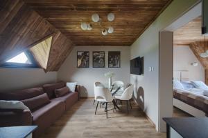 a living room with a couch and a table at Stacja Tatry in Poronin