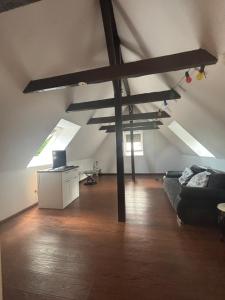 a living room with a black couch in a attic at Gästehaus in Kronshagen +3 photos