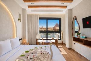 a bedroom with a bed and a view of the pyramids at PANORAMA view pyramids in Cairo +218 photos