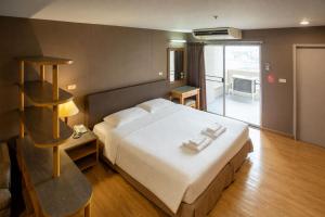 a bedroom with a large white bed in a room at BU Place Hotel in Bangkok