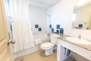 a white bathroom with a toilet and a sink at BU Place Hotel in Bangkok +73 photos