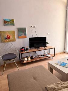 a living room with a television on a table at Alex Apartment in Pogradec