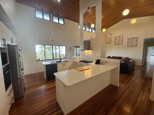 a large kitchen and living room with a counter top at Our Beach House Kingfisherbay in Fraser Island