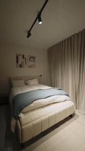 a bedroom with a large bed in a room at مدينتي برافادو in Madinaty