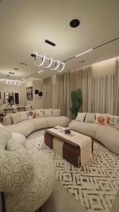 a large living room with couches and a table at مدينتي برافادو in Madinaty