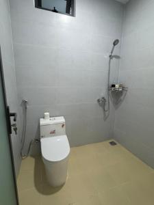 a white bathroom with a toilet in a room at N&N Family in Ngân Hà +20 photos
