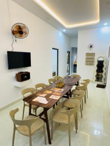 a dining room with a wooden table and chairs at N&N Family in Ngân Hà
